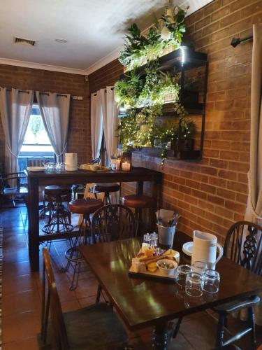 a restaurant with tables and chairs and a brick wall at The Lancefield Lodge in Lancefield