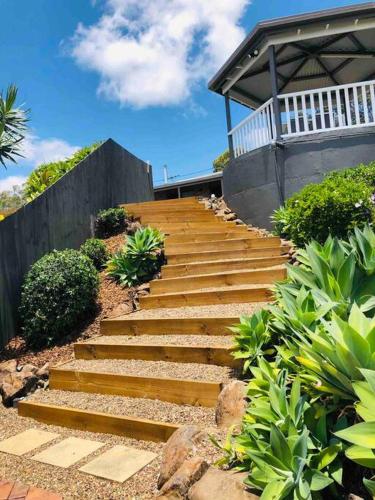 a set of stairs leading up to a house at Stunning Home in Mt Mellum with Panoramic Coastal Views in Bald Knob