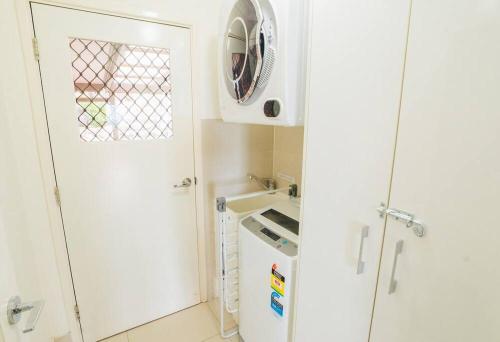 a kitchen with a washing machine and a white appliance at Stunning Home in Mt Mellum with Panoramic Coastal Views in Bald Knob