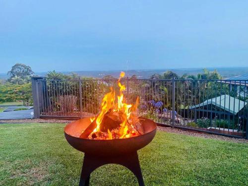 a fire pit in the middle of a yard at Stunning Home in Mt Mellum with Panoramic Coastal Views in Bald Knob