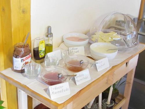 a table with bowls and other food items on it at Wäldebauernhof in Gutach