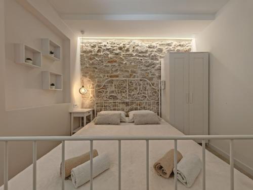 a bedroom with a bed in front of a brick wall at Apartments Mateo in Vodice