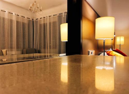 a dining room with a table and two lights at Excelsior INN in Turda