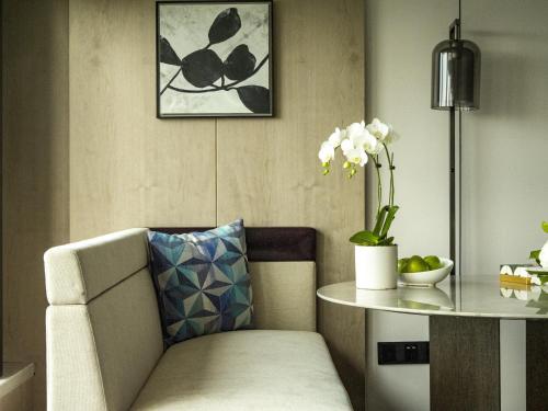 a living room with a chair and a table at Grand Hyatt Beijing in Beijing