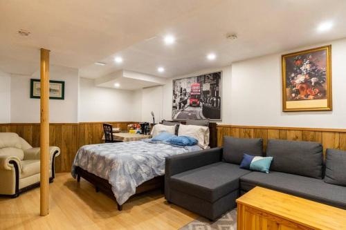 a bedroom with a bed and a couch at BIG Oasis Studio near Airport YYZ in Toronto