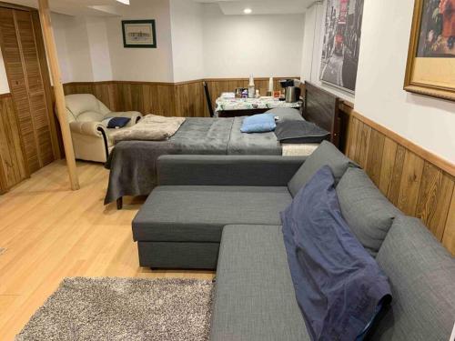 a living room with two beds and a couch at BIG Oasis Studio near Airport YYZ in Toronto