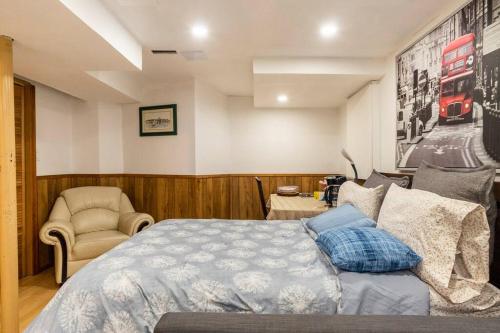 a bedroom with a bed and a chair at BIG Oasis Studio near Airport YYZ in Toronto