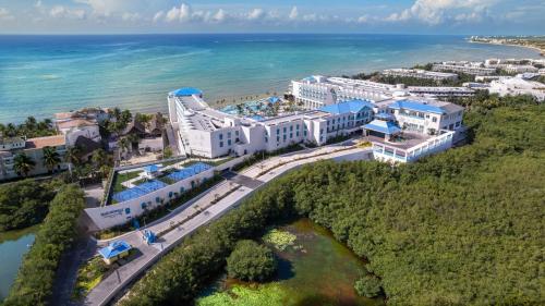 an aerial view of a resort next to the ocean at Margaritaville Island Reserve Riviera Maya - An Adults Only Karisma All-Inclusive Experience in Puerto Morelos