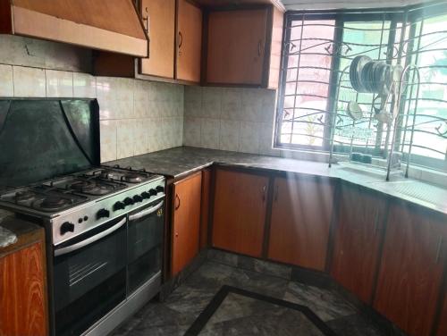 a kitchen with a stove and a counter top at 1 Kanal Entire House with 4 Bedrooms in Lahore