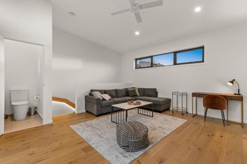 a living room with a couch and a table at StayCentral - Brunswick Central Townhouse in Melbourne