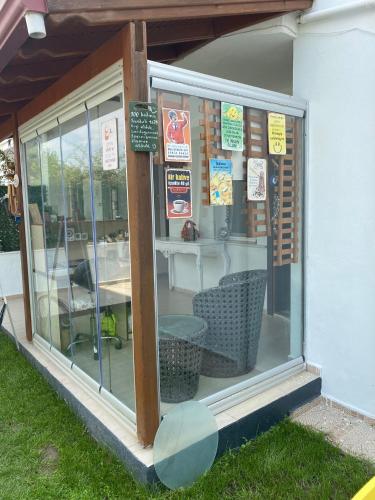 a store window with a table and chairs in it at NEŞELİ APART BAHÇE CAFE in Seferihisar