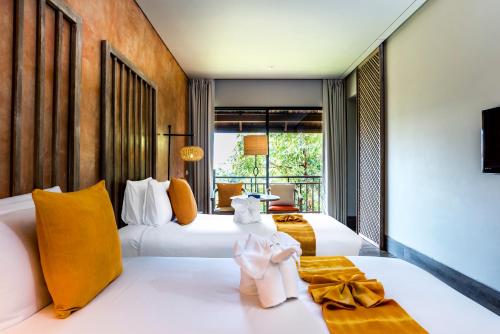 Postel nebo postele na pokoji v ubytování Mercure Samui Chaweng Tana