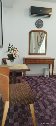 a dining room with a table and a mirror at SofiaSuite16, Plaza Azalea, Shah Alam in Shah Alam