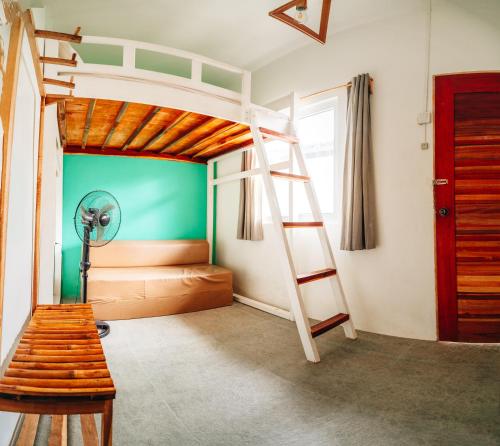 a bedroom with a bunk bed with a ladder at My Green Hostel in San Vicente