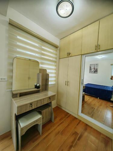 a room with a vanity with a mirror and a bed at Casa Felicitas 1 - Spacious Cozy 1 Bdr Condo At Seawind Condominium in Davao City