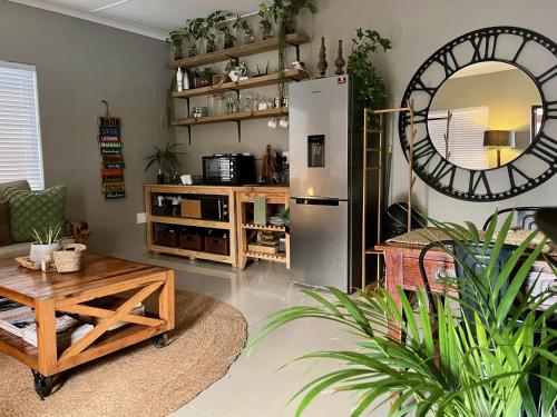 a living room with a refrigerator and a table at The Boshoff in Durban