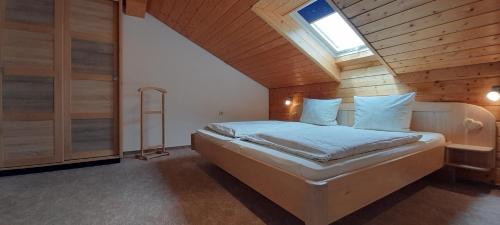 a bedroom with a bed in a wooden room at Ferienwohnungen Gstöttner in Bodenmais