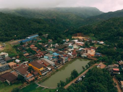 an aerial view of a village next to a river at อีต่องโฮมสเตย์ in Thong Pha Phum