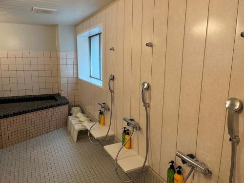 a bathroom with three toilets and a window at Hotel Mayflower Sendai in Sendai