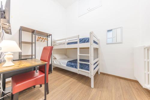 a small room with two bunk beds and a desk at The House of Thrones in Viterbo