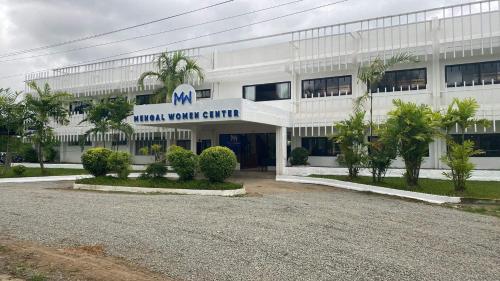 a white building with a sign that reads miami youth center at Casa Maria's Bed & Breakfast in Echague