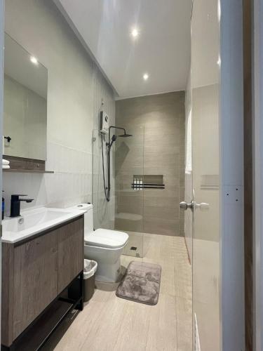 a bathroom with a toilet and a sink and a shower at Casa Maria's Bed & Breakfast in Echague