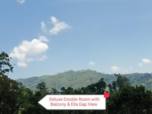 a sign that says believe double room with balcony and elfin gap view at The Rock Face in Ella
