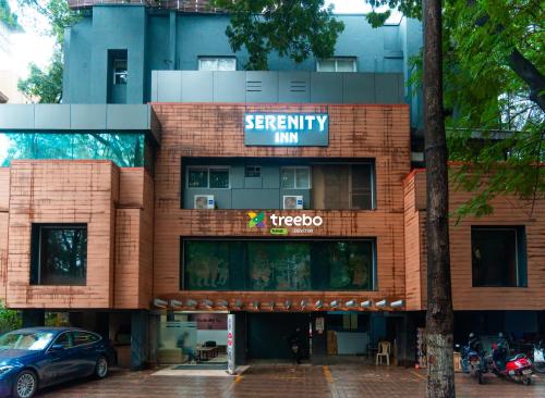 a red brick building with a sign that reads twentymile inn at Treebo Trend Serenity Inn in Pune