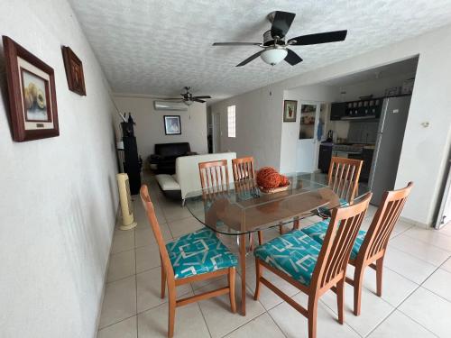 a dining room with a glass table and chairs at Acapulco Marina Diamante in Acapulco