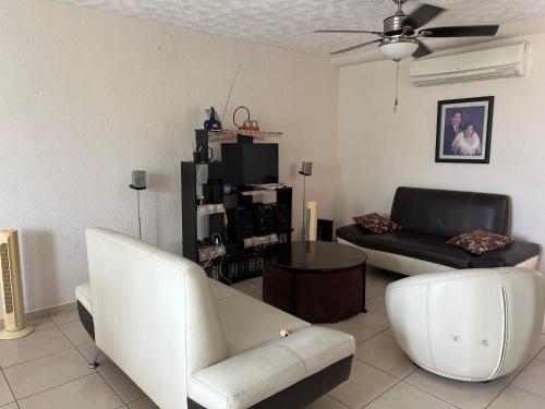 a living room with a couch and a chair at Acapulco Marina Diamante in Acapulco