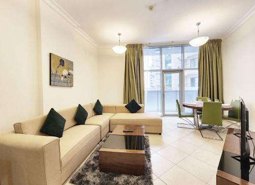 a living room with a couch and a table at RH- Modern Urban Oasis, 02RB near mall of Emirates in Dubai