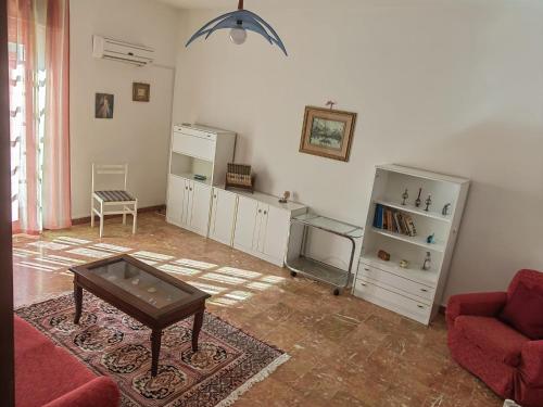 Appartamento Ida vacanza mare في بوليكورو: غرفة معيشة مع أريكة وطاولة