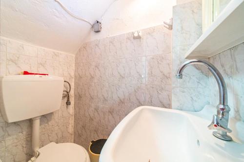 a bathroom with a toilet and a sink at Captain Spiros House in Lákones