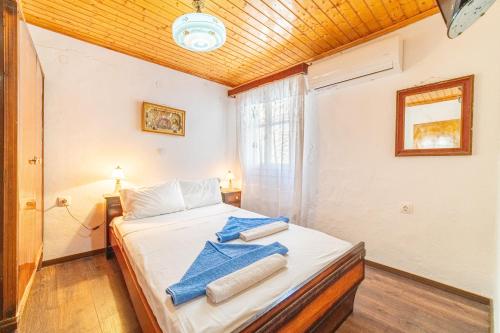 a bedroom with a bed with towels on it at Captain Spiros House in Lákones