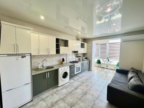 uma cozinha e sala de estar com um sofá e um frigorífico em Apartment in center premium em Ivano-Frankivsk