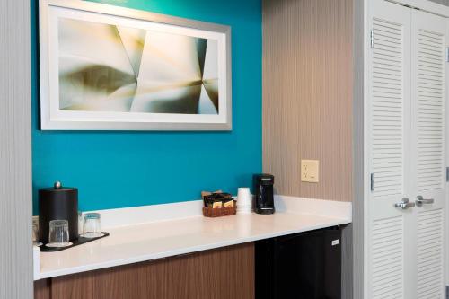 a bathroom with a white counter and a blue wall at Courtyard by Marriott Traverse City in Traverse City