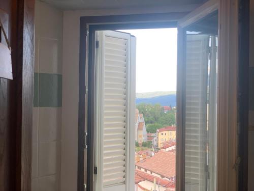 an open window with a view of a city at Colle House in Rivisondoli