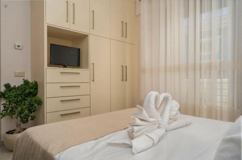 a bedroom with a bed with a towel on it at Villa Debora in Zakynthos Town