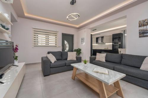 a living room with two couches and a table at Villa Debora in Zakynthos Town