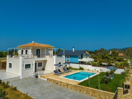 a villa with a swimming pool and a house at Villa Debora in Zakynthos Town