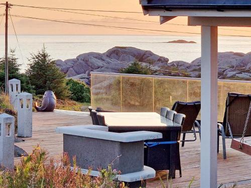 a table and chairs with a view of the ocean at 6 person holiday home in skudeneshavn-By Traum in Skudeneshavn
