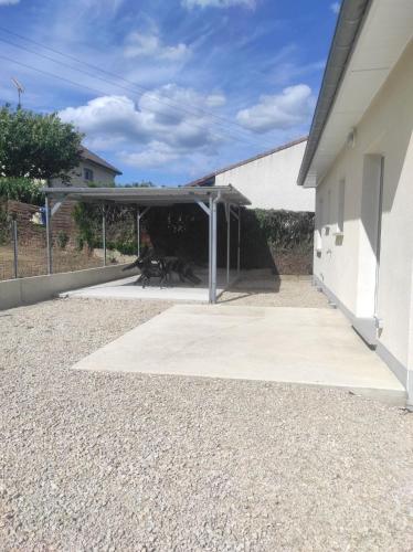 a garage with awning next to a building at Chez CHARLETTE 