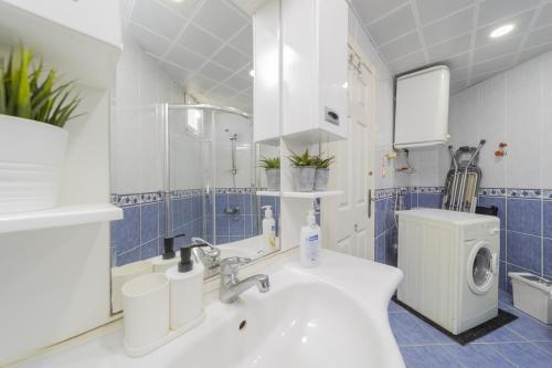a bathroom with a sink and a washing machine at Residence w Terrace Garden 15 min to Belek Beach in Belek