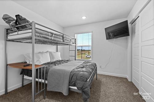 a bedroom with a bunk bed and a desk at Pacific Palace-NEW 2bed 2 5bath Home in Centerton in Bentonville