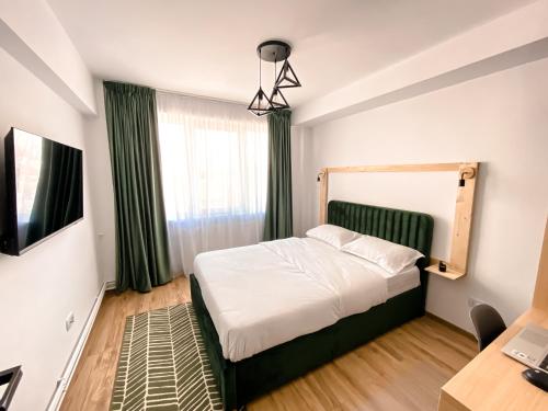 a small bedroom with a bed and a desk at Central Station Two-Bedroom Family Apartment in Timişoara
