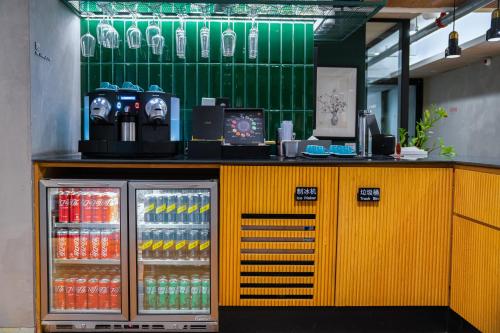 a yellow counter with drinks on top of it at Stey Wangfujing Hotel in Beijing