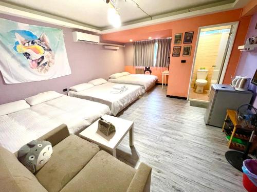 a hotel room with two beds and a couch at Fengchia Oslo in Taichung