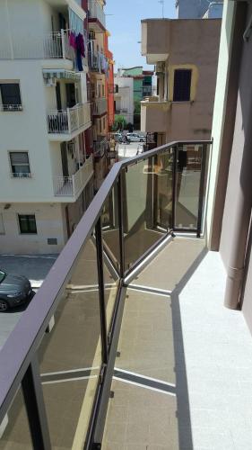 a balcony of a building with glass railing at L'angolo Zen in Margherita di Savoia