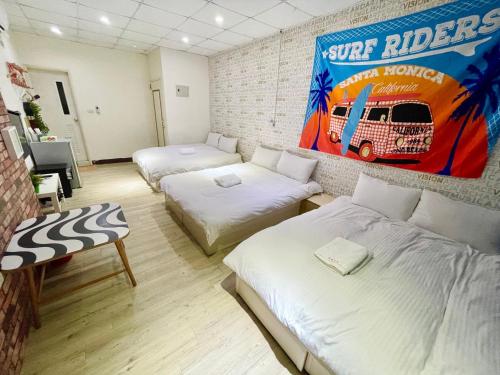 a room with two beds and a poster of a truck at Fengchia Oslo in Taichung