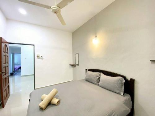 a bedroom with a bed with a teddy bear on it at Modern Cozy Sweet House 4 ROOM 10pax@ALMA BM in Bukit Mertajam